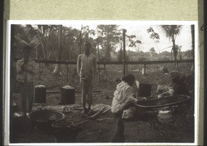 Before the wedding. The metal containers contain rice. The women are cutting vegetables for djoho, a vegetable soup