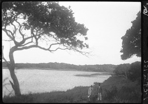 African men standing in front of a lake, Mozambique