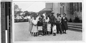 Two Maryknoll Sisters with a group of indigenous people in front of Baguio cathedral, Baguio, Philippines, May 4, 1938