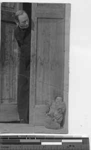 Fr. Fraser and new orphan at Zhigong, China, 1941