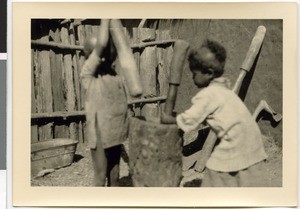 Children pounding corn, Ayra, Ethiopia