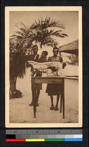 Two women weighing infants on a table, Congo, ca.1920-1940