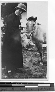 Rev. Mark A. Churchill, MM, with a mule at Luoding, China, 1931