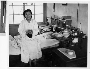 Japanese woman sitting on a hospital bed, Kyoto, Japan, ca. 1949