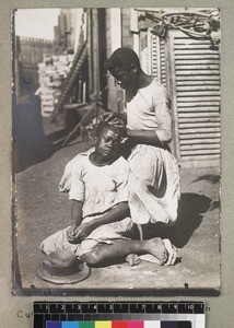 Cutting hair with glass, Madagascar, ca. 1910