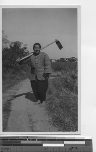 A farmer carrying his hoe in South China, 1935