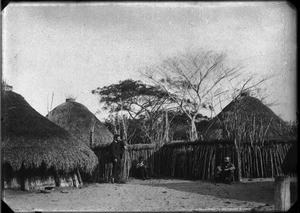 Swiss missionaries in front of huts, Mozambique, ca. 1896-1911