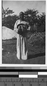 Man standing outside holding a hat, Africa, ca. 1920-1940