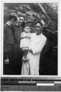 Two Maryknoll priests with a Japanese father and daughter, Japan, ca. 1920-1940