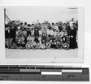 Fr. John Donovan with children's school in Meixien, China, 1945