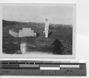 Fr. McDermott at Sister Gertrude's grave at Yangjiang, China, 1933