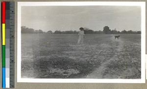 Mrs. Norton stands on the land intended for Industrial Work, Vārānasi , India, ca. 1920