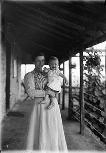 Missionary Elisabeth Müller with baby on veranda, Tanzania, ca.1893-1920