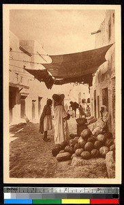 Woman selling vegetables in the street, Ghardaïa, Algeria, ca.1920-1940