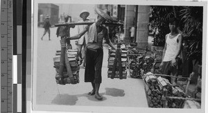 Man carrying firewood, Hong Kong, China, ca. 1930