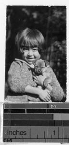 Japanese girl holding a dog, Japan, ca. 1920-1940