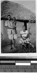 Family outside of a house, Africa, December 1948