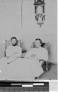 Two priests smoking a pipe, Uganda, Africa, September 1, 1913