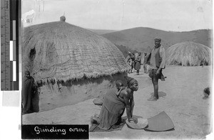 Woman grinding corn in a village, Union of South Africa, Africa, ca. 1920-1940