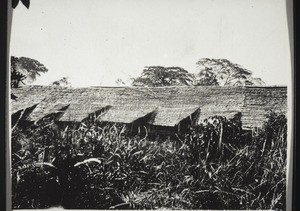 Rumah Riam. Back of a house with window and aperture for smoke. Each individual family has a room of this kind with aperture for smoke