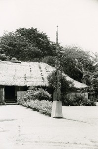 A sculpted post at the entrance of a building