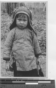 A child who collects cigarette tins at Gaozhou, China, 1936