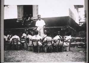 A Junior School class in Akropong doing hand-work (plaiting palm-leaves and fibres)