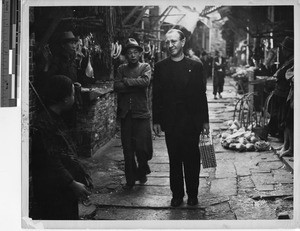 Fr. Meyer walking the streets in Guangzhou, China, 1948