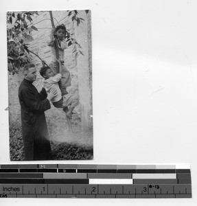 Fr. McDermott with twins at Taishan, China, 1935