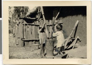 Children pounding corn, Ayra, Ethiopia