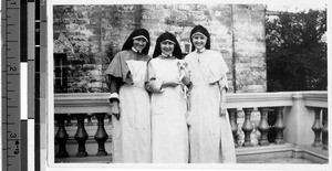 Three Maryknoll Sisters standing on the back porch of their convent, Malabon, Philippines, 1928