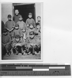 Fr. McDermott with girls at Yangjiang, China, 1929