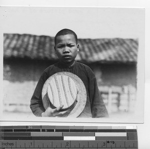 A boy holding his hat at Rongxian, China, 1934