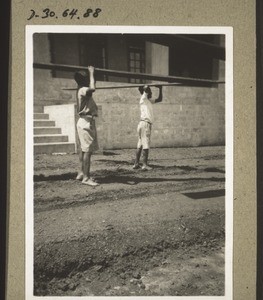 Africans preparing for the festival (carrying planks for the rostrum)