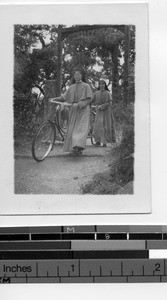 Sisters using bicycles at Meixien, China, 1947