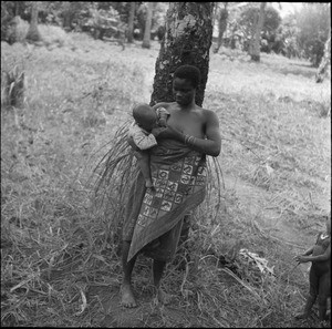 Young African woman feeding her baby