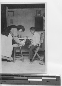 Sr. Mary DeLourdes in dispensary at Yangjiang, China, 1923