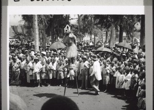 A man on stilts performs for hours on the day of the coronation