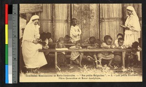 Nun overseeing young students at wooden benches, Madagascar, ca.1920-1940