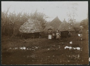 African family in front of rural homestead, Tanzania