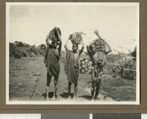 Workmen carrying bricks, Chogoria, Kenya, ca.1925