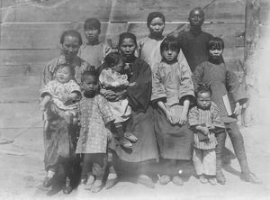 Firstfruits of the mission in Chang Chun. The girl with the stiff leg to the right and the litt