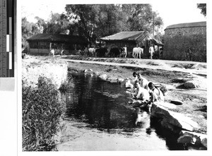 Group women washing clothing in a river, Loting, China, ca. 1935