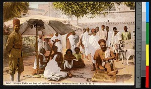 Man sitting on a bed of spikes, Benares, India, ca.1920-1940