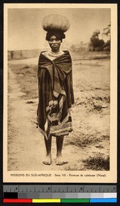 Girl poses carrying a calabash, South Africa, Africa, ca.1920-1940