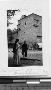 Maryknoll Sister Regina Marie talking to a local woman, Wuchow, China, 1949