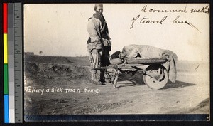 Man lying down on a barrow pushed by another, Haizhou, Jiangsu, China, ca.1914-1915