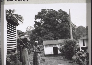 Schoolgirls leaving for their christmas holiday. Their box, their sleeping mat, everything is carried on their heads