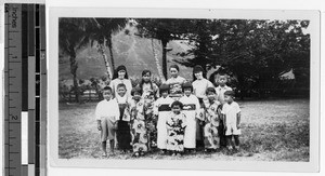 Two Maryknoll Sisters standing outdoors with a group of Japanese children, Hawaii, 1932