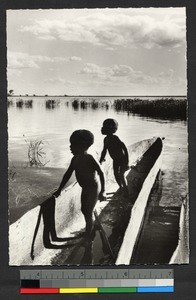 Two children in a canoe, Zambia, Africa, ca.1954-1964